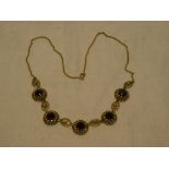 A 9ct gold necklace set five garnets