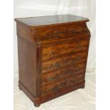 A 19th Century figured mahogany chest of four long drawers with brass ring handles below a hinged