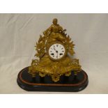 A 19th Century French gilt spelter mantel clock with circular enamelled dial in ornate case
