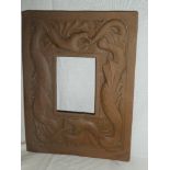 An unmarked Newlyn copper rectangular photo frame with raised dragon decoration,