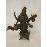 An Indian bronze figure of a deity playing a sitar,