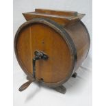 An old oak circular metal-bound butter maker with hand cranked handle