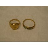 A 9ct gold dress ring set turquoise (one stone missing) and a 9ct gold signet ring with heraldic