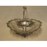 An Edward VII silver oval pedestal cake basket with pierced and raised decoration and swing handle,