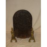A good quality iron fire grate with brass ornamental dogs and 27" arched fire back decorated with a