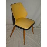 A 1960's occasional chair upholstered in yellow and black vinyl