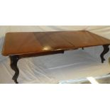 A mid Victorian figured mahogany extending dining table with three additional centre leaves on