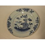 An 18th Century Chinese circular plate with blue and white floral decoration,