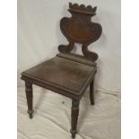 A Regency mahogany hall chair with urn-shaped back and polished seat on turned tapered legs