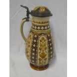 A 19th Century German Mettlach lidded stein jug decorated in relief with flowers and scrolls,