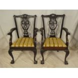 A set of four single and two carver mahogany Chippendale-style dining chairs with pierced vase