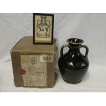 A good quality black and gilt glazed two handled vase modelled on the Portland vase with classical