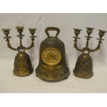 A reproduction brass mantel clock in the form of a bell with circular decorated dial and individual