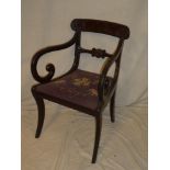 An early 19th Century carved mahogany carver armchair with decorated rail back and tapestry