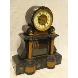 A 19th Century mantle clock with part visible escapement in polished marble and black slate arched