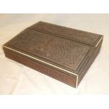 An Eastern carved teak and sandalwood rectangular double opening writing slope with fitted interior,