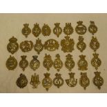 A collection of 29 brass numbered Glengarry badges,