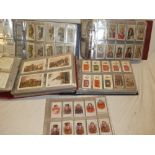 Four albums containing a selection of sets and part sets of cigarette cards - mainly military,