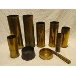 A selection of First and Second War brass shell cases including two German First War brass shell