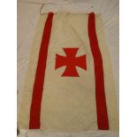An old linen flag with red Maltese Cross emblem,