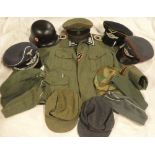 A selection of copy German Second War military uniforms and head dress including officer's tunic,