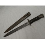 A Middle East bayonet with single edged blade in steel scabbard