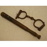 A 19th Century painted police truncheon 13½" long and a pair of old iron handcuffs