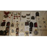 A selection of various cloth military badges including divisional signs, shoulder titles,