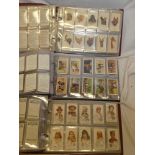 Three albums containing sets and part sets of cigarette cards including Wills - Association