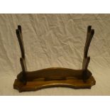 A modern stained wood Japanese sword stand