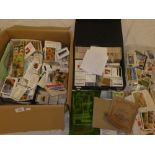 A box containing a large selection of part sets of cigarette cards - varying ages