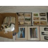 A large album containing a selection of black and white and coloured postcards including some