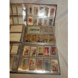 Three albums containing sets and part sets of cigarette cards including Godfrey Phillips - In the