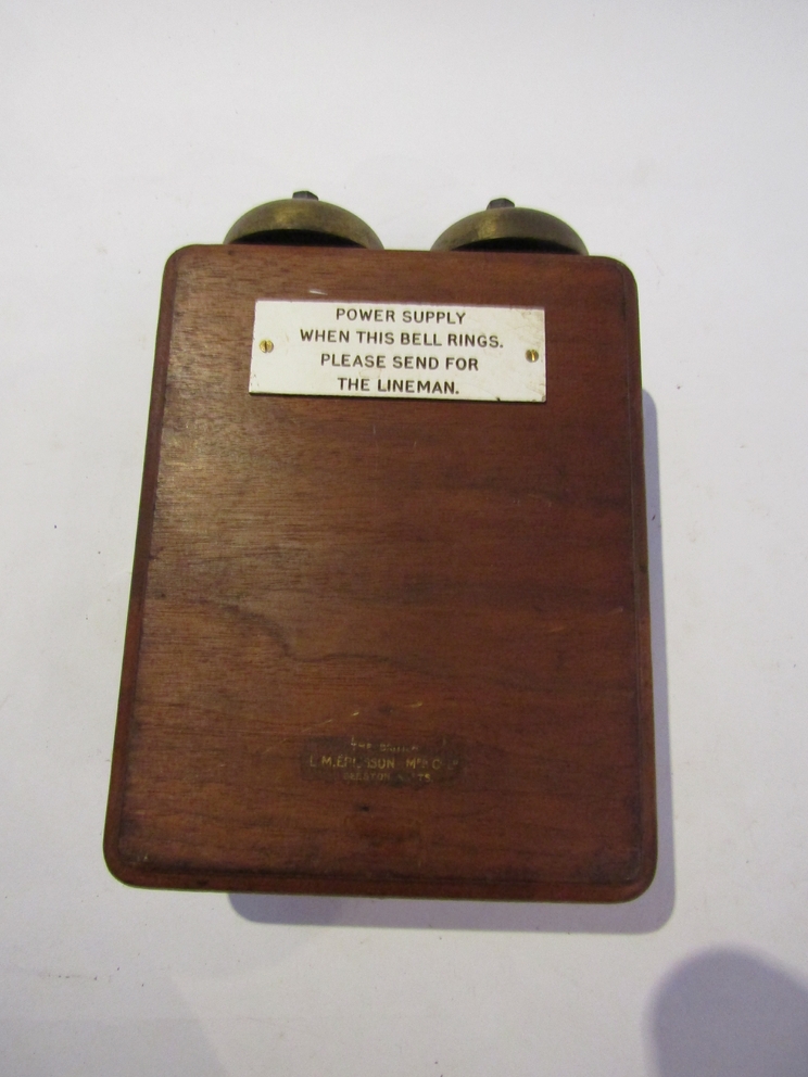 An L.M Ericsson block shelf power supply alarm bell, plaque to the front