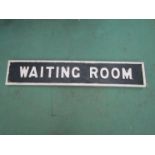 A wooden WAITING ROOM board with cast metal letters,