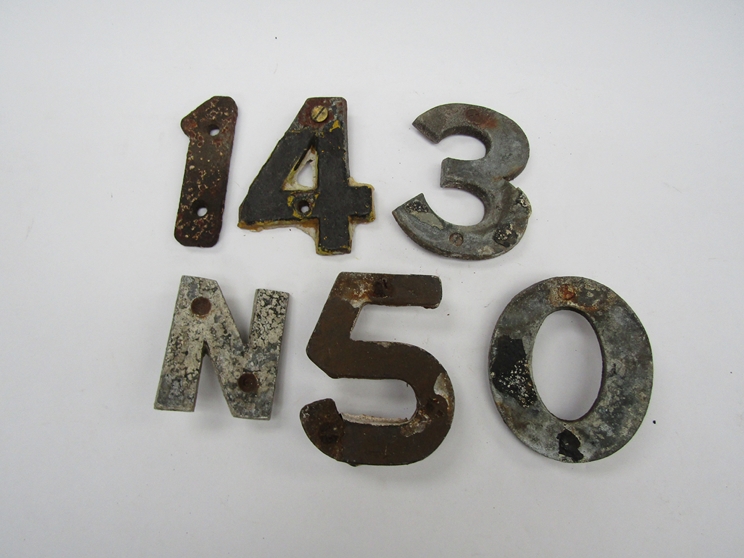 A quantity of cast alloy sleeper identification numbers and letters