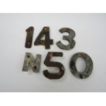 A quantity of cast alloy sleeper identification numbers and letters