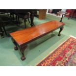 A mahogany window seat on cabriole legs with carved ball in claw feet,