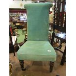 A Victorian green velour nursing chair with turned front legs to castors