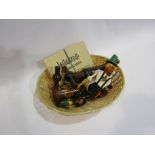 A basket containing Austrian playing cards, Swiss wooden corkscrews,