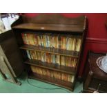 An Edwardian oak bookshelf with height adjustable shelves over a bracket foot plinth base,