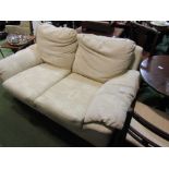 A two seater cream upholstered sofa with geometric patterns,