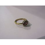 A 9ct gold ring set with three rubies enclosed by six individually set diamonds. Size O/P, 2.