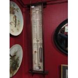 An Admiral Fitzroy barometer with paper charts,