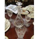 A decanter and a good selection of mixed crystal drinking glasses