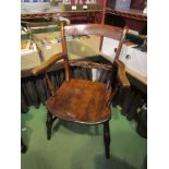 Circa 1850, a Suffolk elm knife back elbow chair with carved bar rest on ring turned legs,