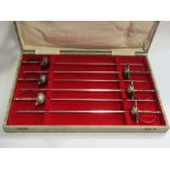 A cased set of skewers in the form of swords