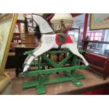 A carved wooden rocking horse with dappled paintwork, on trestle rocker, 92cm wide,