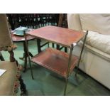A Continental brass two tier occasional table with leather inset top,