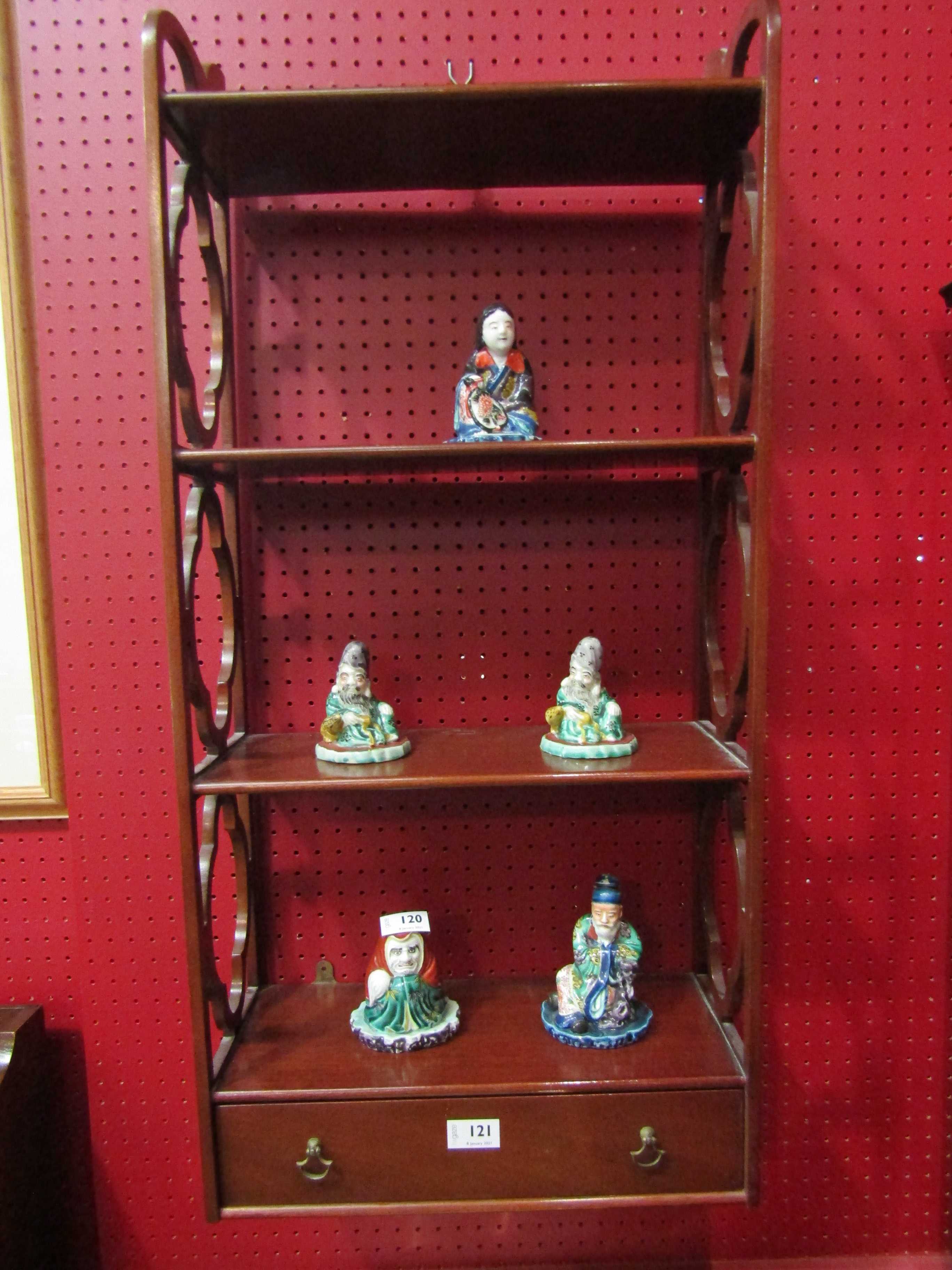 A wall hanging shelf with pierced sides and lower drawer,